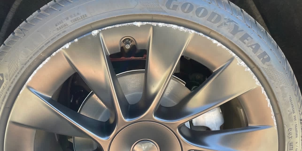 Before: Tesla Model Y 21-inch Überturbine wheel with curb rash damage